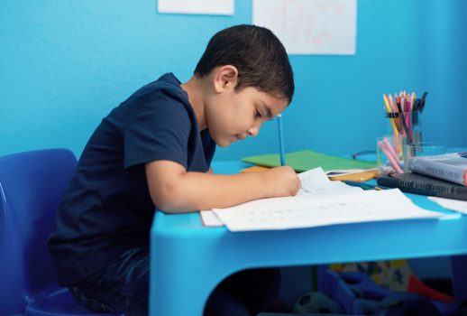 Writing, notebooks and child with homework in house for education, learning or development with knowledge. Scholarship, kid and boy student studying mathematics for school assignment in apartment.